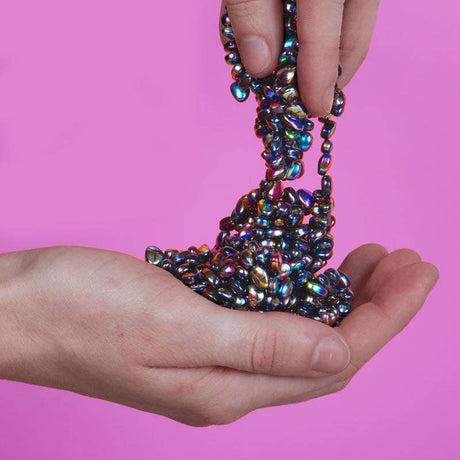 Speks Crags Oil Slick iridescent magnetic fidget putty being poured into hand