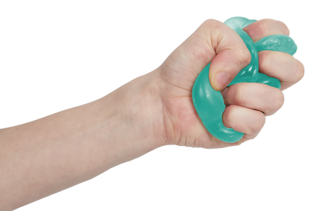 Fist squeezing a mint green Speks Gump tree squishy into a twist, stretchy sensory toy