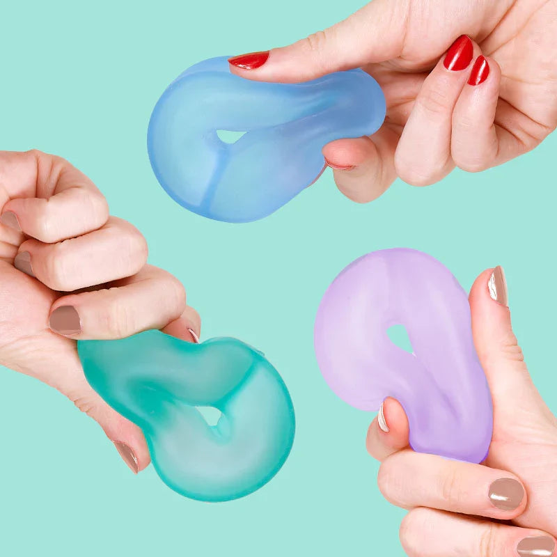 Hands squeezing lilac, blue and teal Speks Gump Loop squishy fidget toy rings