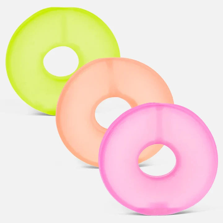 Three frosted Speks Gump Loop memory gel sensory toy rings in lime, peach and pink