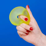 Algae green Speks Gump Loop memory gel stress ring held in hand, fidget toy