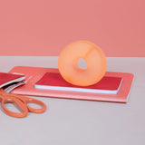 Reef orange Speks Gump Loop memory gel stress ring on desk, fidget toy