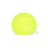 Single bright yellow-green Speks Gump Original memory gel stress ball on a white background