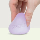 Hand stretching a lilac Speks Gump Original memory gel stress ball showing its pliable gel texture