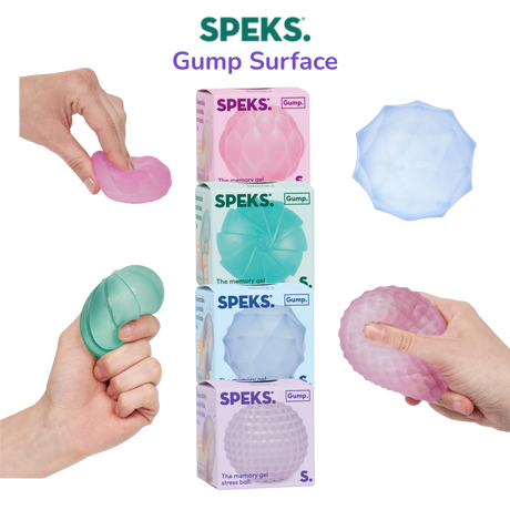Four Speks Gump Surface memory gel stress balls in pink, teal, blue and purple, shown with packaging on a transparent background