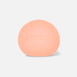 Single peach Speks Mini Gump memory gel stress ball on a white background