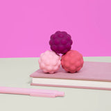 Speks Odds Purple Bumps sensory fidget magnets on book, desk toy