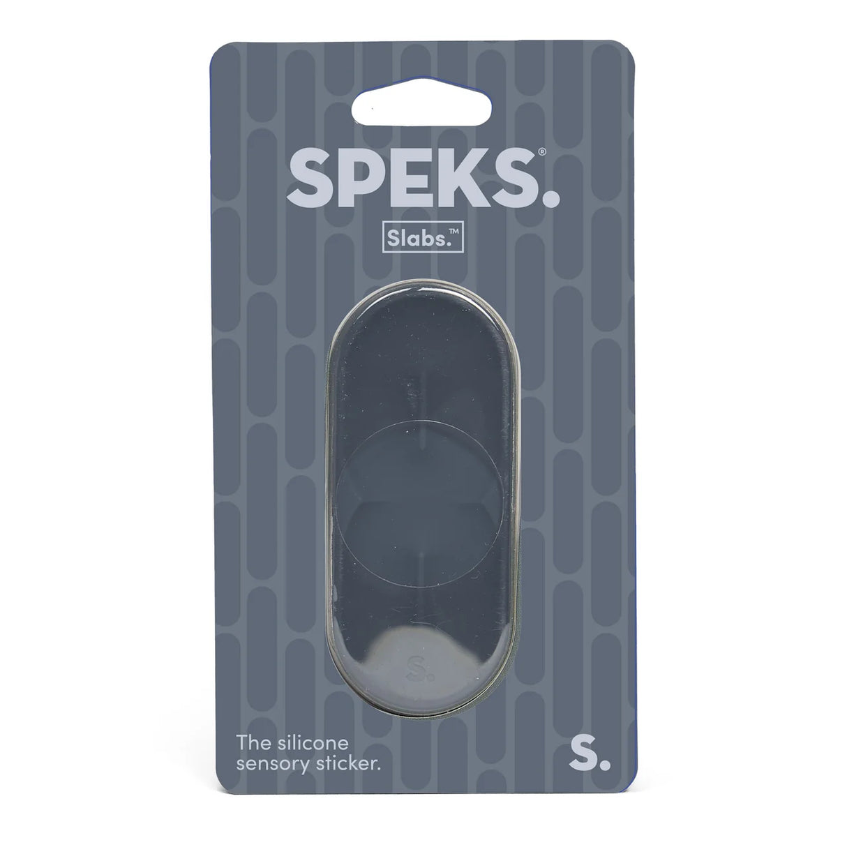 Speks Slabs S silicone sensory sticker in its original retail packaging, featuring a dark gray oval-shaped sticker visible through a clear plastic window on a dark gray patterned backing card.