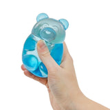 Blue jelly bear sensory toy being squeezed in hand, soft squishy fidget toy