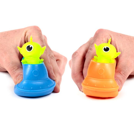 Squeezy Alien UFO Pop Out in blue and orange — both colours shown in hands
