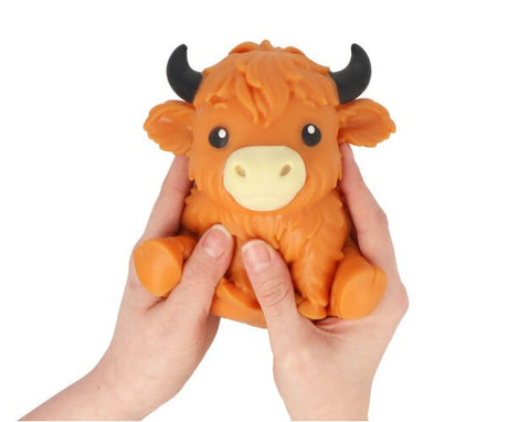 Squeezy Highland Cow orange squishy stress fidget toy held in two hands