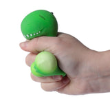 Squeezy-O green dinosaur squishy sensory toy squeezed in hand, belly bulge