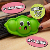 Kawaii pea pod squishy stress toy sitting on a wooden desk beside a keyboard