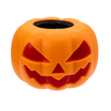 Angled view of the orange Squeezy Pumpkin Ghost Pop Out toy with spooky face