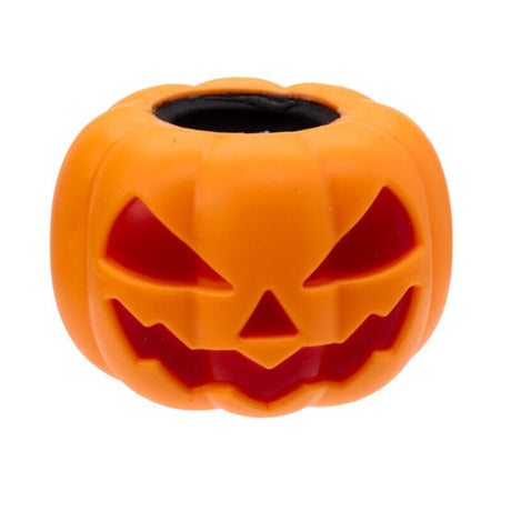 Angled view of the orange Squeezy Pumpkin Ghost Pop Out toy with spooky face