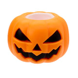 Front angled view of the orange Squeezy Pumpkin Ghost Pop Out toy with hollow top