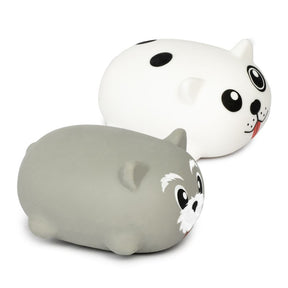 Two squidgy puppy fidget toys side by side — a white spotty dog and a grey husky design