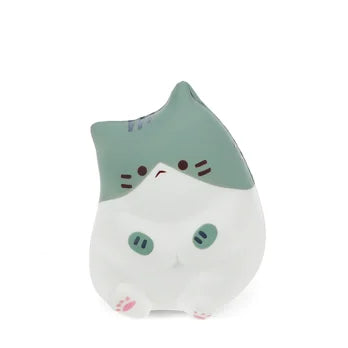 Front view of a green and white kawaii sitting cat squishy toy with pink paws and stripe markings