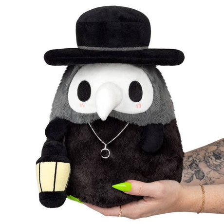 Squishable Mini Mysterious Doctor Plague black grey plush held in hand front