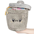 Squishable Mini Trash Can grey plush with open lid and colourful trash interior, held in hand