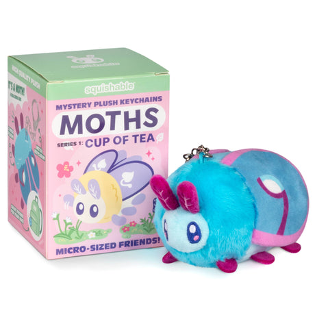 Plush keychain toy resembling a moth next to its packaging on a white background