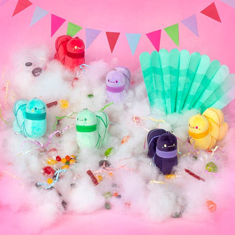 Colorful plush toys on a pink background with cotton candy and flags