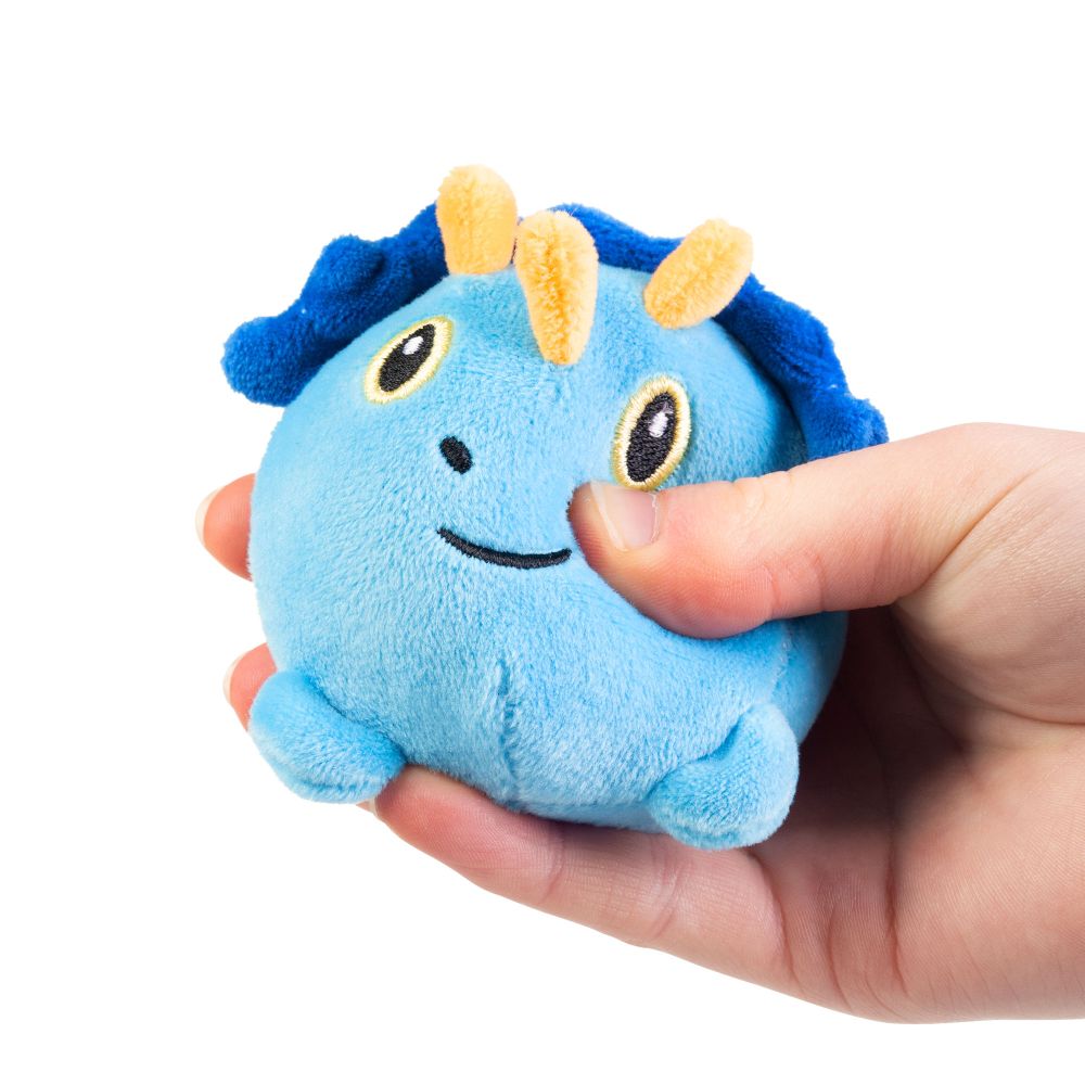 Hand squeezing blue triceratops squishy dinosaur plush sensory toy demonstrating soft sugar-filled texture