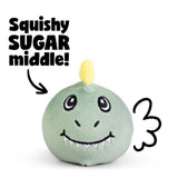 Green squishy dinosaur plush sensory toy with yellow horn and embroidered smile showing squishy sugar-filled middle