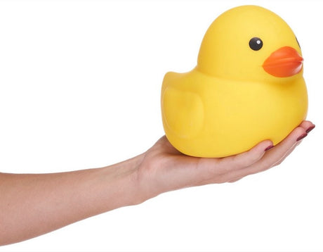 Large yellow squishy duck balanced on an open palm showing size