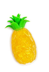 Close-up of yellow glitter gel pineapple squishy fidget toy with bright green leaf crown