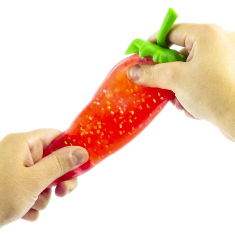 Two hands stretching a red glitter gel strawberry squishy fidget toy to show its elasticity