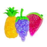 Three glitter gel squishy fruit fidget toys — pineapple, grape and watermelon slice — shown together