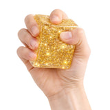 Gold glitter squishy cube sensory stress toy being squeezed