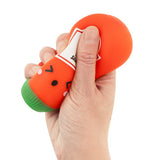 Hand squeezing a red kawaii hot sauce squishy bottle fidget toy, showing the satisfying squish
