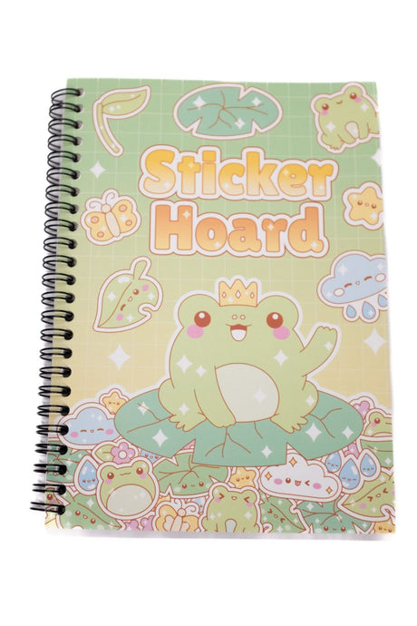 A spiral-bound notebook with a cute sticker-themed cover titled 'Sticker Hoard'. The cover features a green cartoon frog wearing a gold crown sitting on a leaf, surrounded by various pastel-colored stickers on a light green and yellow gradient background.