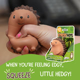 Two hands squeezing the Stress Hog kawaii hedgehog squishy, with packaging visible in the background