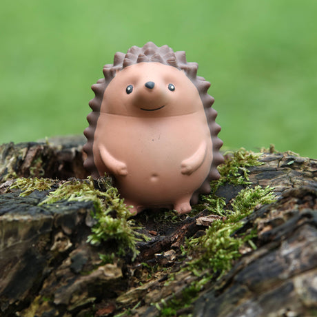 Stress Hog kawaii hedgehog squishy standing upright on a mossy log outdoors