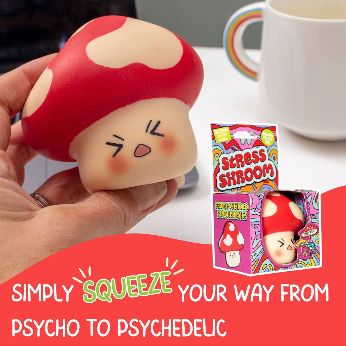Hand holding the Stress Shroom kawaii mushroom squishy at a desk with packaging visible