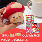 Hand holding the Stress Shroom kawaii mushroom squishy at a desk with packaging visible