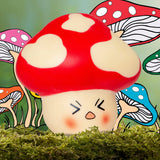 Stress Shroom kawaii mushroom squishy surrounded by illustrated colourful mushrooms on moss