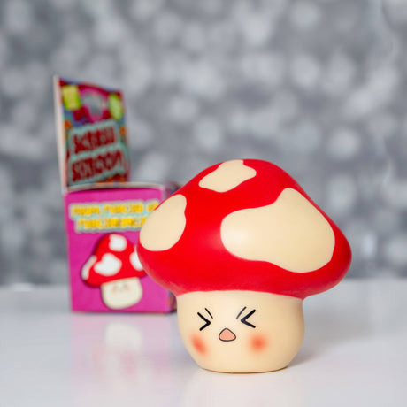 Stress Shroom kawaii red mushroom squishy displayed out of its box against a bokeh background