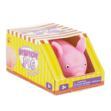 Pink stretchy pig stress toy displayed in its yellow and orange Stretchy Pig branded gift box