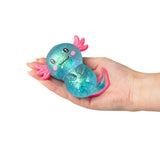 Blue large glitter gel Sugar Axolotl squishy resting in an open palm showing teal iridescent glitter