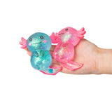 Open palm holding blue and pink large Sugar Axolotl squishies showing their size