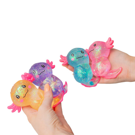 Two hands each holding and squeezing large glitter gel Sugar Axolotl squishies in orange, purple, blue and pink