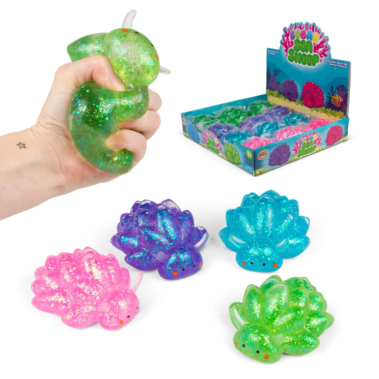 All four Sugar Sea Sheep glitter squishy fidget toys in pink, purple, blue and green with retail display box