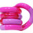 Pink and lilac Tangle Classic fidget toy coiled into its resting spiral shape with glitter segment detail