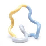 Blue, grey and lemon Tangle Jr. Clouds fidget toy twisted into a flowing wavy shape