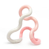 Pink and white Tangle Jr. Clouds twisty fidget toy twisted into loops and curves