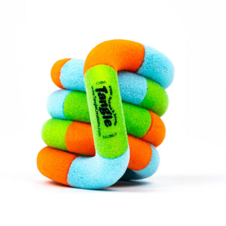 Orange, green, and blue Tangle Jr. Fuzzy fidget toy coiled into its resting spiral shape showing soft velvety texture